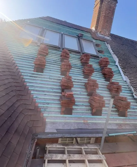 New Roofs & Skylights in Guildford | Mitchell's Roofing new clay tile roof with skylights, membrane and battens during professional installation in Guildford — Mitchell's Roofing